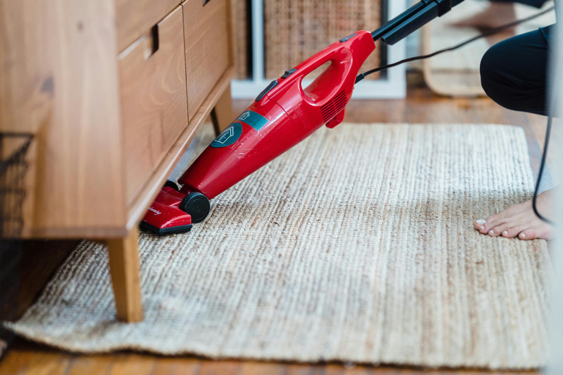 An area rug being vacuumed